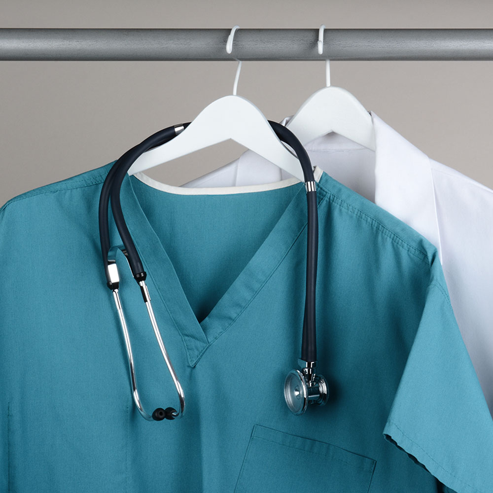 Veterinary team member in uniform representing uniform allowance benefit at Peak Pet Urgent Care
